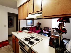 Fayetteville apartment for rent - a kitchen with a stove top oven next to a living room