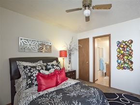 Fayetteville apartment for rent - a bedroom with a bed and a ceiling fan
