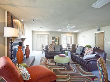 Fayetteville apartment for rent - a living room with couches and chairs and a fireplace