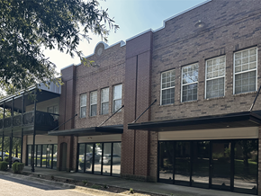 Fayetteville apartment for rent - the front of a brick building with glass windows
