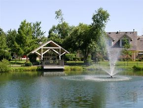 Fayetteville apartment for rent - a fountain in the middle of a lake with a gazebo