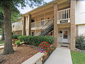Fayetteville apartment for rent - an apartment building with a staircase and a porch with flowers