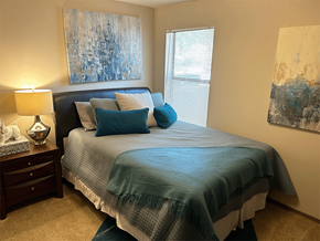 Springdale apartment for rent - a bedroom with a bed and two paintings on the wall