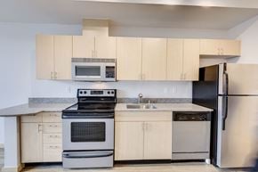 Seattle apartment for rent - a kitchen with stainless steel appliances and white cabinets