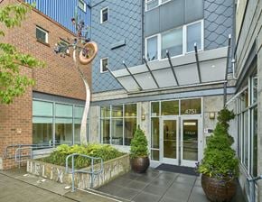 Seattle apartment for rent - the entrance to a building with a bike sculpture in front of it