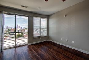 Charlotte apartment for rent - the living room of an apartment with wood floors and a view of the city