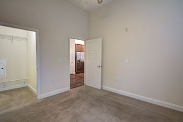 Charlotte apartment for rent - a living room with carpet and a door to a bedroom
