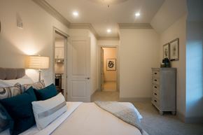 Charlotte apartment for rent - a bedroom with a bed and a hallway to a bathroom