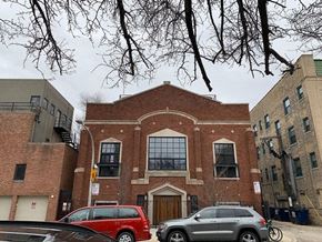 Chicago apartment for rent - a brick building with cars parked in front of it