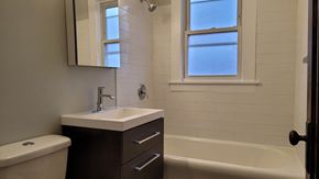 Chicago apartment for rent - A white sink with a silver faucet is on a brown vanity.