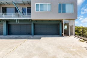 San Francisco apartment for rent - A two-story house with a garage and a balcony.