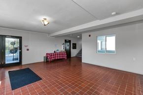 San Francisco apartment for rent - A room with a red tile floor and white walls.