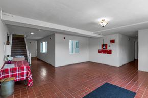 San Francisco apartment for rent - A room with red tiled floors and a table with a red and white checkered tablecloth.