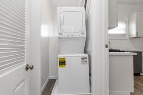 San Francisco apartment for rent - A white toilet with a yellow caution sticker on the side is in a small room.
