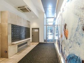 New York apartment for rent - the lobby of a building with a door and a marble wall