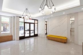 New York apartment for rent - a large lobby with a yellow bench in the middle of it