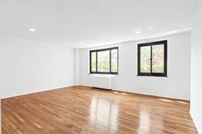 New York apartment for rent - an empty living room with wood floors and a window