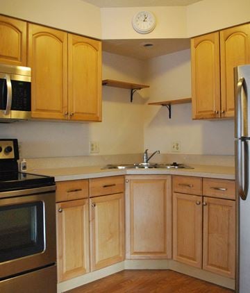 Mankato apartment for rent - a kitchen with wooden cabinets and stainless steel appliances