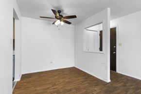Palos Hills apartment for rent - a living room with white walls and a ceiling fan