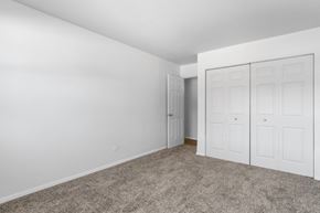 Palos Hills apartment for rent - a bedroom with white walls and carpet and white doors