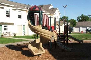 Columbia Heights apartment for rent - a playground with a slide in front of a house