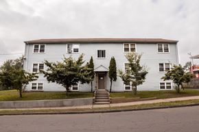 New Haven apartment for rent - A grey house with a brown roof and a front door.