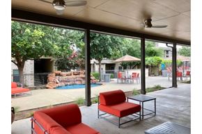 New Braunfels apartment for rent - a patio with red chairs and a swimming pool