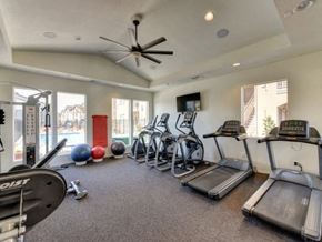 Chico apartment for rent - Chico California Apartments for Rent-Eaton Village-Fitness Center with Equipment, Large Windows, and a Ceiling Fan