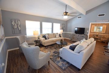 Flowood apartment for rent - a living room with couches and chairs and a tv