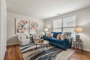 Huntsville apartment for rent - A living room with a blue couch, two chairs, and a coffee table.