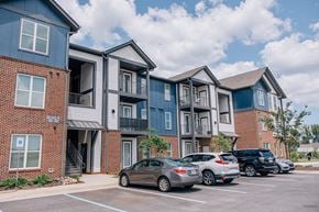 Madison apartment for rent - A parking lot in front of a multi-story apartment building.