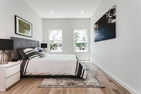 Jersey City apartment for rent - A bedroom with a large bed and a painting on the wall.