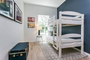 Jersey City apartment for rent - a bunk bed and a trunk in a bedroom with a window