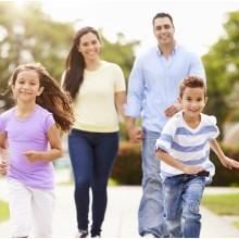 Stockton apartment for rent - A family of four is running together in a park.