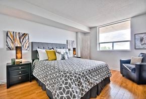 Ottawa apartment for rent - a bedroom with a bed and a window