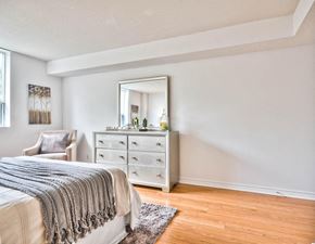 Ottawa apartment for rent - a bedroom with a bed and a dresser with a mirror