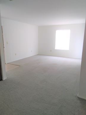 Normangee apartment for rent - an empty room with carpet and a window