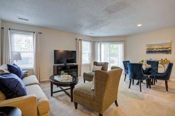Baltimore apartment for rent - a living room with a couch and chairs and a tv
