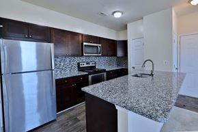 Baltimore apartment for rent - a kitchen with granite counter tops and stainless steel appliances