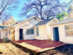 Denton house for rent - A white house with a red deck in front.