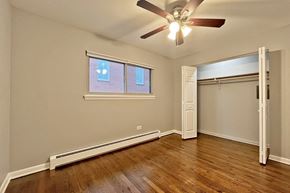 Oak Park apartment for rent - A room with a ceiling fan and a window with blinds.