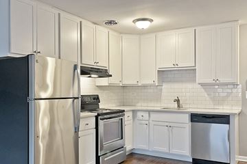 Oak Park apartment for rent - A kitchen with white cabinets and appliances.