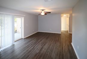 Camp Hill apartment for rent - an empty living room with wood floors and a ceiling fan