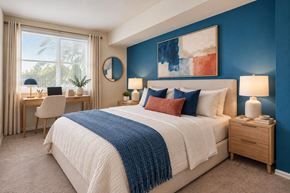 Alexandria apartment for rent - A bedroom with a large bed and a desk with a chair.