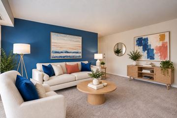 Alexandria apartment for rent - A living room with a white sofa, a wooden coffee table, and a painting on the wall.