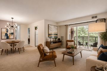 Alexandria apartment for rent - A living room with a brown chair and a white couch.