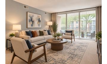Alexandria apartment for rent - A living room with a white couch, a wooden coffee table, and a painting on the wall.