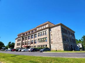 Albion apartment for rent - a large brick building with cars parked in front of it