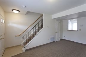 Albion apartment for rent - the upstairs landing of a home with a staircase and a white door