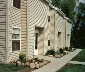 Kent townhouse for rent - A beige house with a white door and windows.